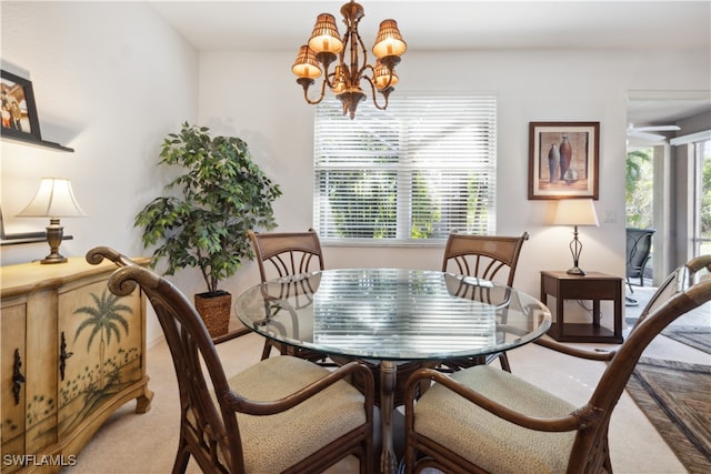 dining area with light colored carpet and a chandelier