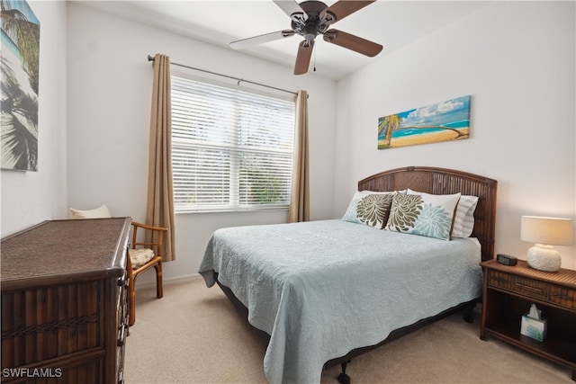 bedroom with light colored carpet and ceiling fan