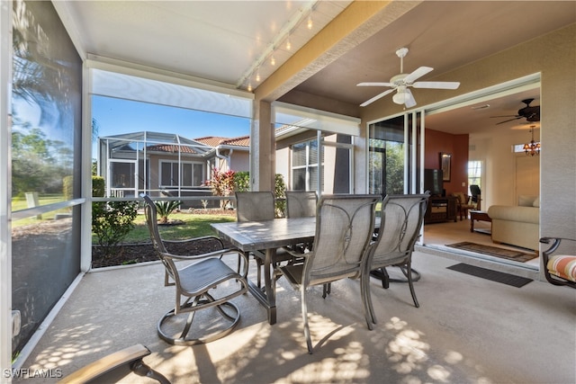 sunroom / solarium featuring ceiling fan and rail lighting