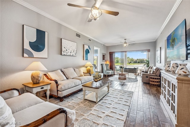 living room featuring ceiling fan, light hardwood / wood-style floors, and crown molding