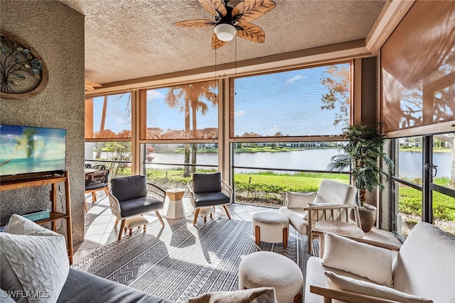 sunroom with a water view and ceiling fan