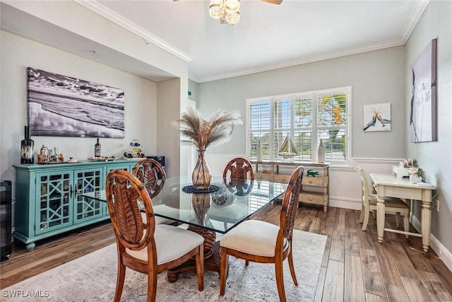 9229 Museo Cir Unit 102, Naples, FL 34114 - dining space with wood finished floors, crown molding, a wainscoted wall, ceiling fan, and baseboards