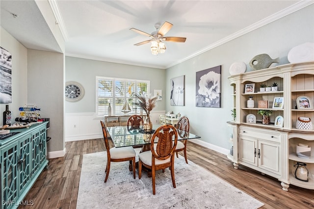 dining space with dark hardwood / wood-style floors, ceiling fan, and crown molding