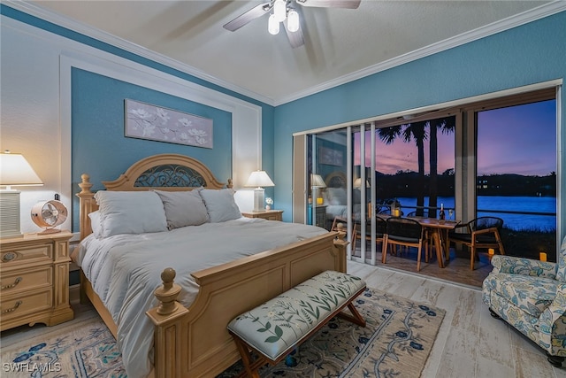 bedroom featuring light wood-type flooring, a water view, ceiling fan, and crown molding