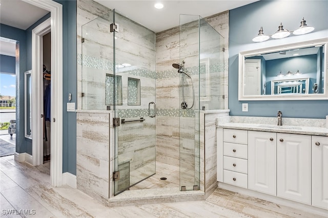 bathroom featuring a shower with door, vanity, and wood-type flooring