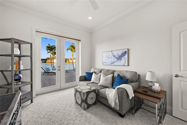 carpeted living room featuring ceiling fan, french doors, a water view, and ornamental molding