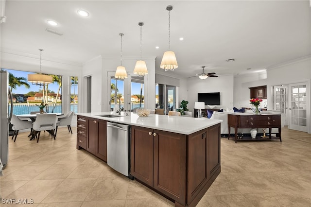 kitchen with ceiling fan, french doors, sink, stainless steel appliances, and an island with sink