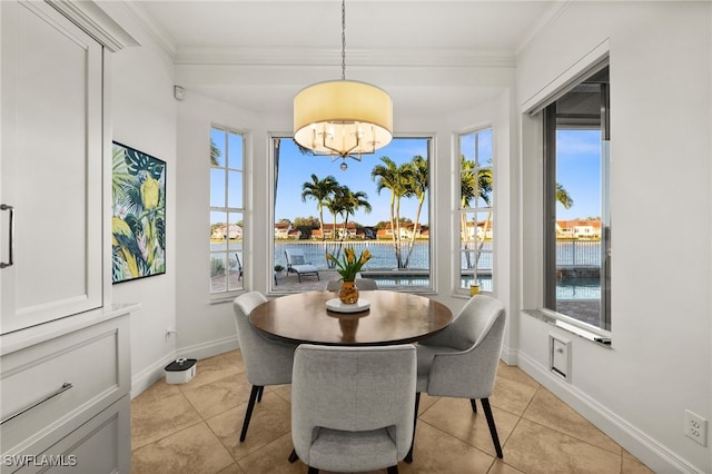 dining room featuring a chandelier, a water view, ornamental molding, and light tile patterned flooring