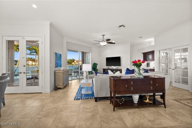 tiled living room featuring ceiling fan, french doors, and ornamental molding