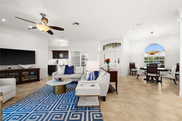 tiled living room featuring ceiling fan and crown molding