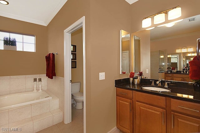 bathroom featuring tile patterned flooring, tiled tub, crown molding, toilet, and vanity