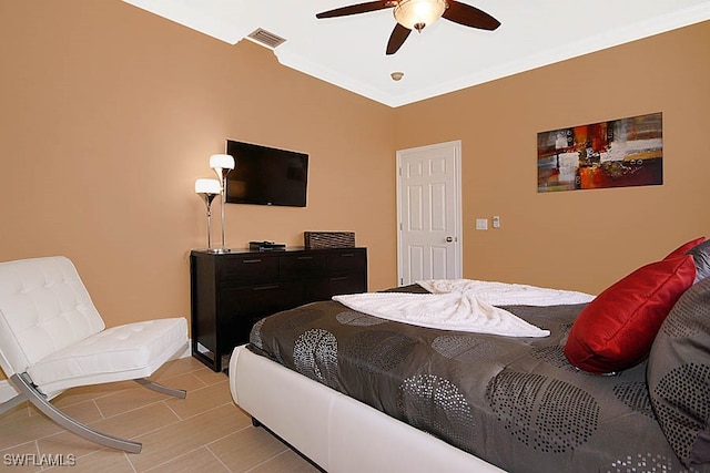 bedroom featuring ceiling fan and crown molding