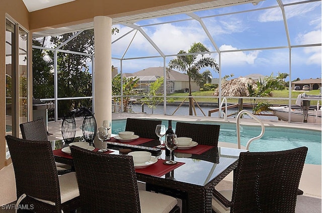 sunroom / solarium with a water view and a swimming pool