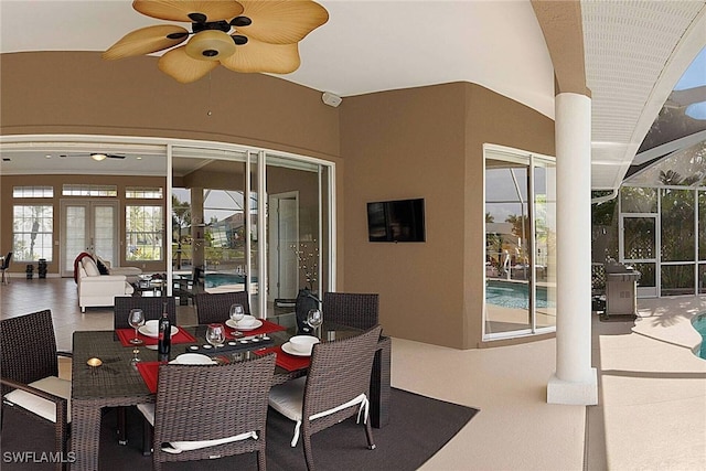 view of patio / terrace with an outdoor hangout area, glass enclosure, and ceiling fan