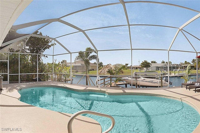 view of pool with a patio, a water view, a dock, and a lanai