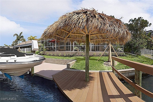 view of dock with a lawn and a water view