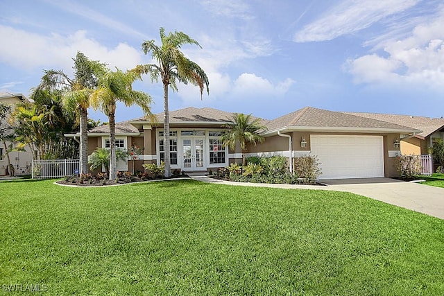 single story home featuring a garage, a front yard, and french doors