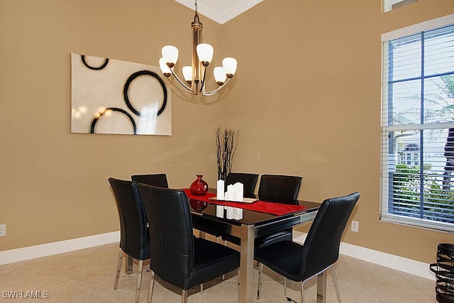 dining room featuring a chandelier, crown molding, and light tile patterned flooring