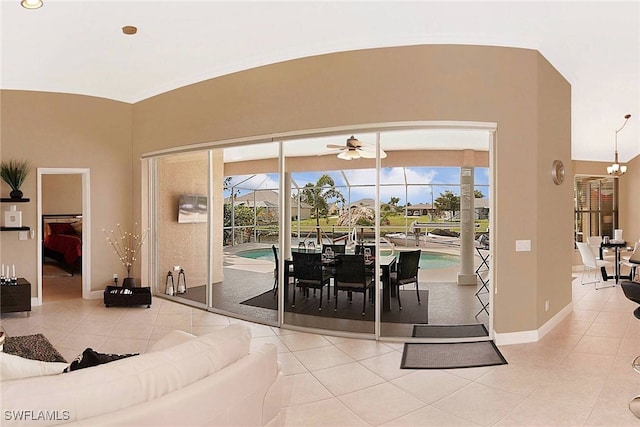 dining space featuring lofted ceiling, tile patterned floors, and a healthy amount of sunlight