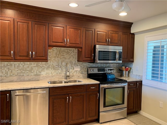 200 Periwinkle Way Unit 332, Sanibel, FL 33957 - kitchen with stainless steel appliances, a sink, tasteful backsplash, and light stone counters