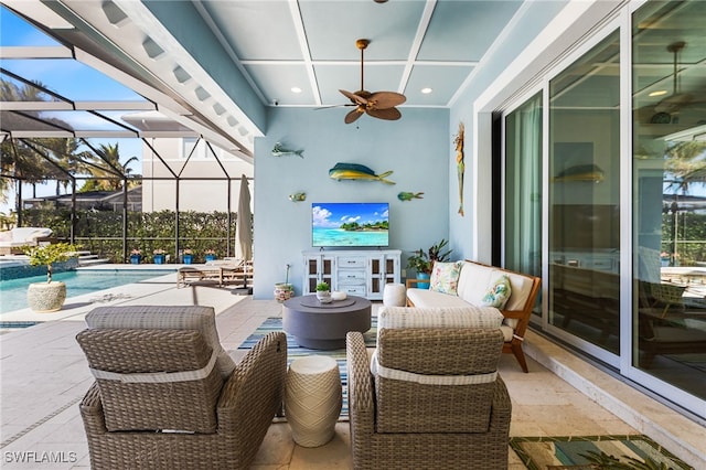 view of patio featuring a lanai and ceiling fan