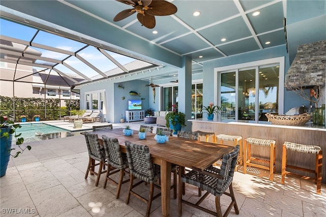 view of patio with a fenced in pool, glass enclosure, ceiling fan, and a bar