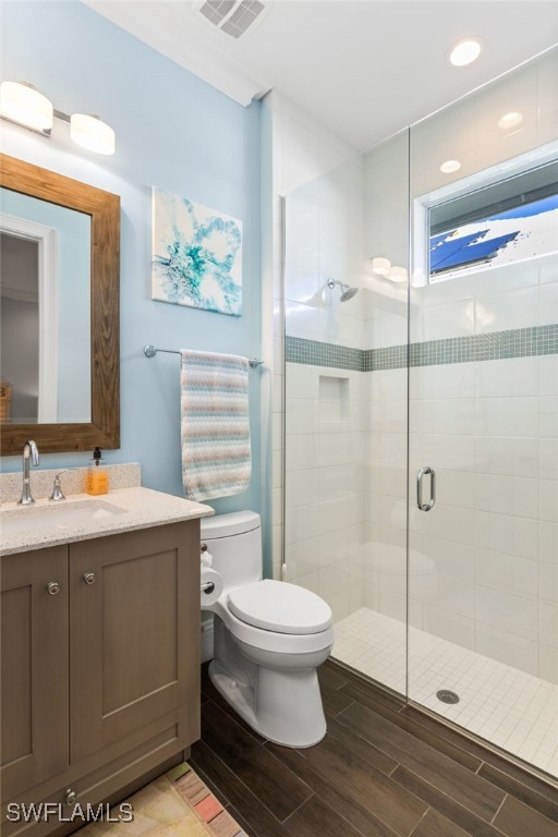 bathroom with vanity, toilet, and an enclosed shower