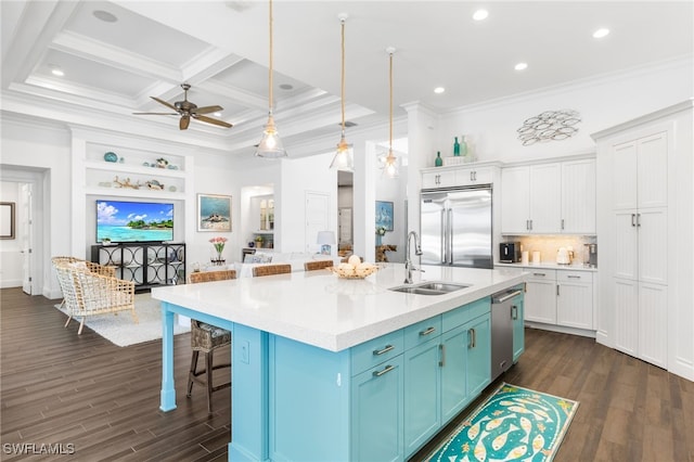 kitchen featuring white cabinets, hanging light fixtures, sink, appliances with stainless steel finishes, and a large island