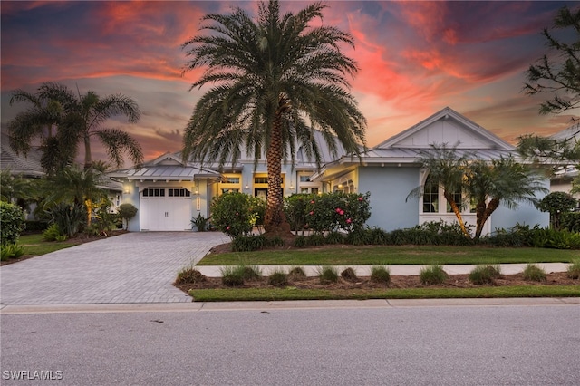 view of front facade with a lawn and a garage