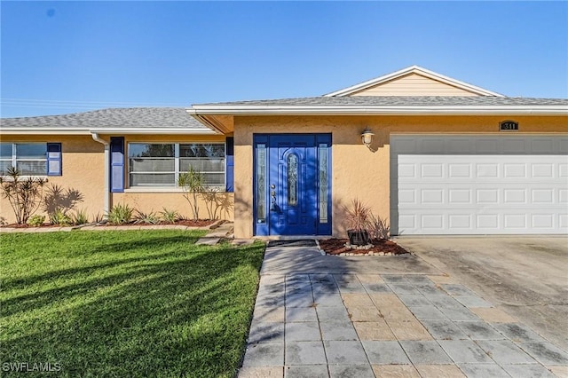 view of front of property with a front yard and a garage