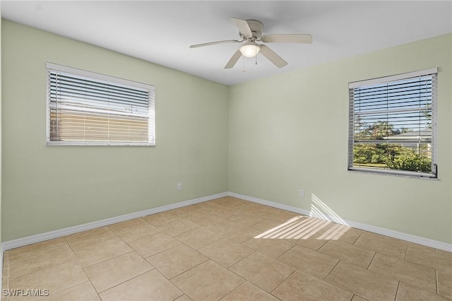 tiled empty room featuring ceiling fan