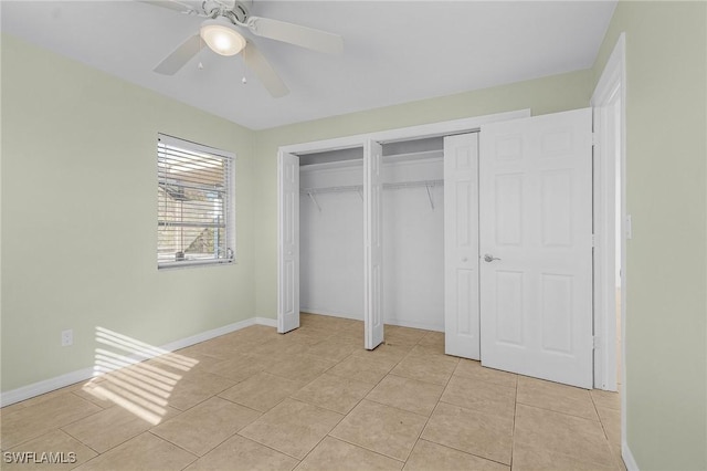 unfurnished bedroom featuring multiple closets, ceiling fan, and light tile patterned flooring