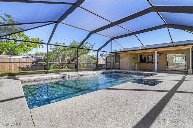 view of pool featuring ceiling fan, a patio, and glass enclosure