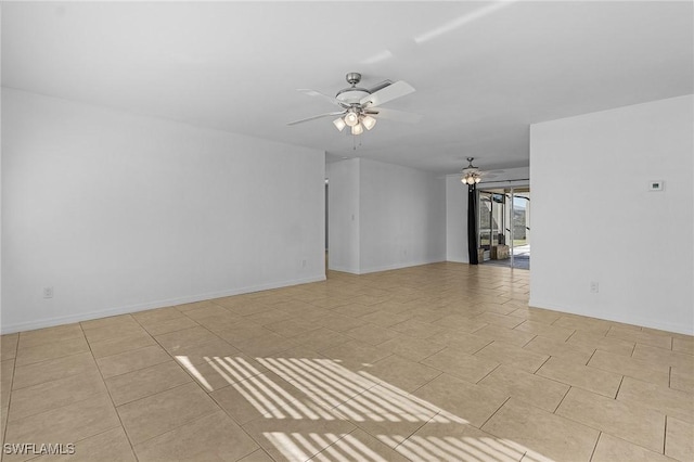 empty room featuring ceiling fan and light tile patterned floors