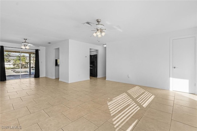 tiled empty room featuring ceiling fan