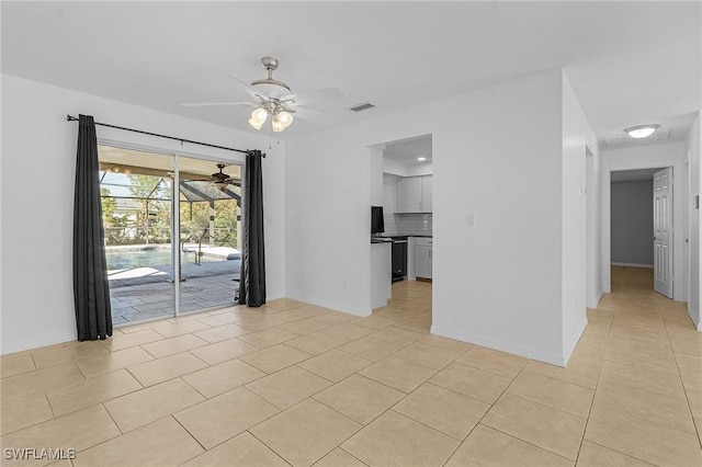 tiled spare room featuring ceiling fan