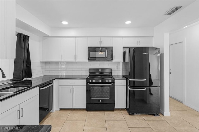 kitchen with black appliances, white cabinets, light tile patterned floors, and sink