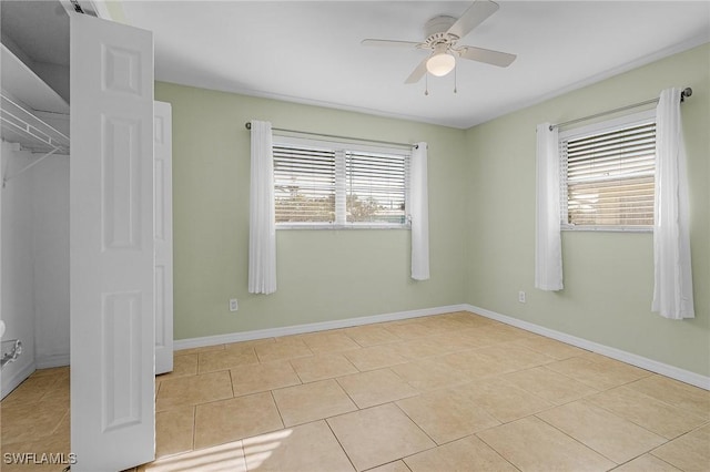 unfurnished bedroom with ceiling fan and light tile patterned floors