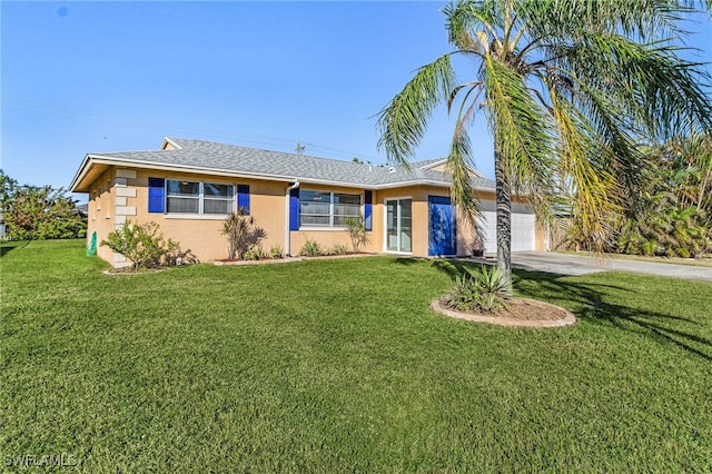 single story home featuring a garage and a front lawn