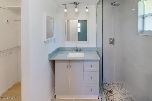 bathroom with vanity and a shower with shower door