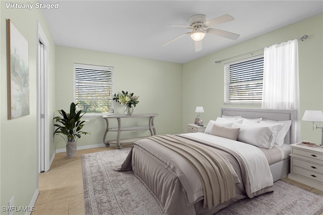 tiled bedroom featuring multiple windows and ceiling fan