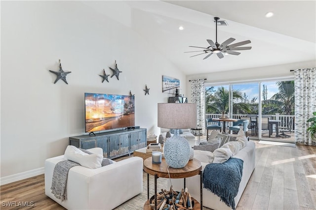 living room with ceiling fan, light wood-type flooring, and high vaulted ceiling