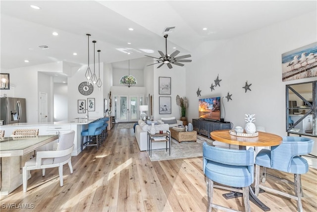 living room featuring french doors, light wood-type flooring, high vaulted ceiling, and ceiling fan