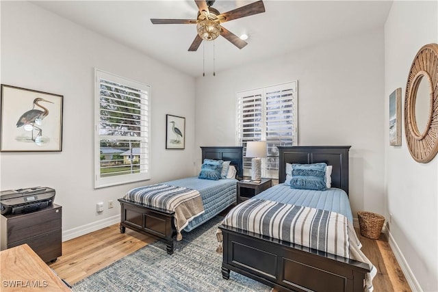 bedroom with ceiling fan and wood-type flooring