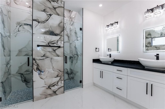 bathroom featuring vanity and a shower with door