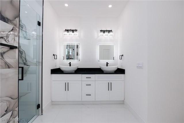 bathroom featuring vanity and a shower with door