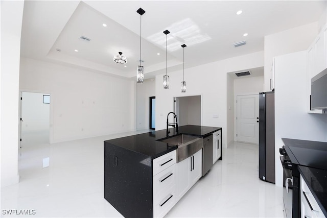 kitchen featuring white cabinetry, hanging light fixtures, sink, and appliances with stainless steel finishes