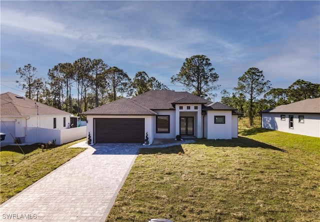 view of front of home featuring a front yard and a garage