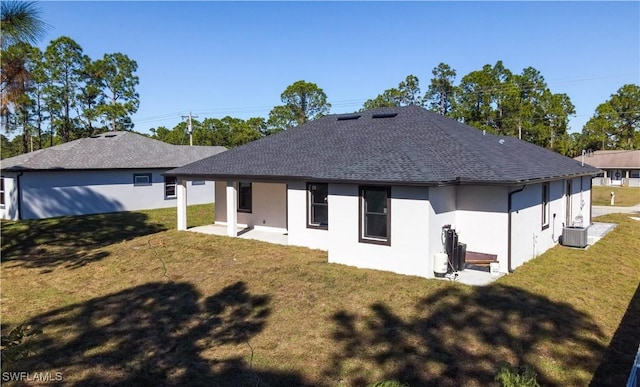 back of property with cooling unit, a patio area, and a yard