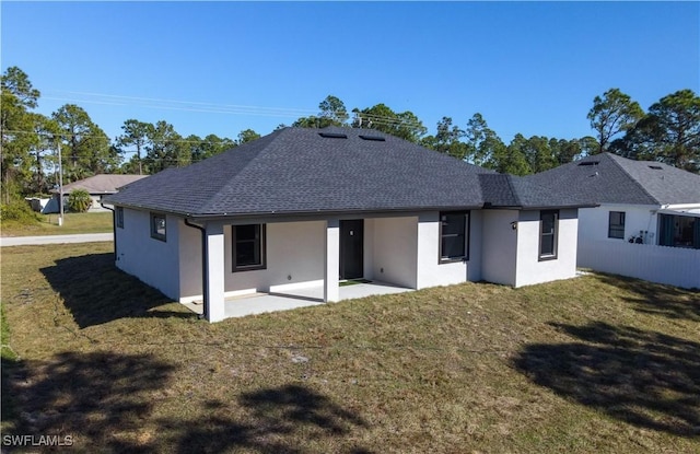 back of property featuring a yard and a patio